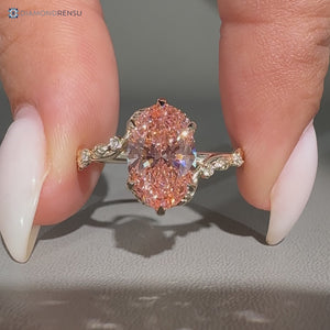 Pink center diamond oval engagement ring with bypass setting.