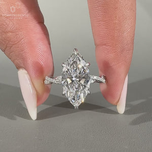 Twisted pave band with marquise and round diamonds.
