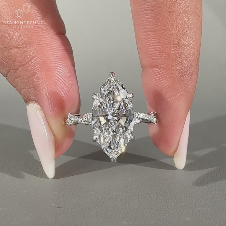 Twisted pave band with marquise and round diamonds.
