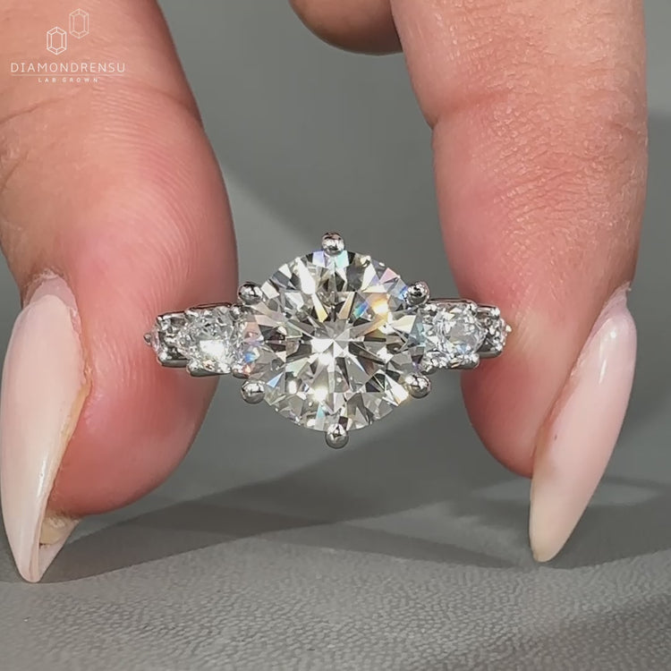 Five stone diamond ring with round center diamond.
