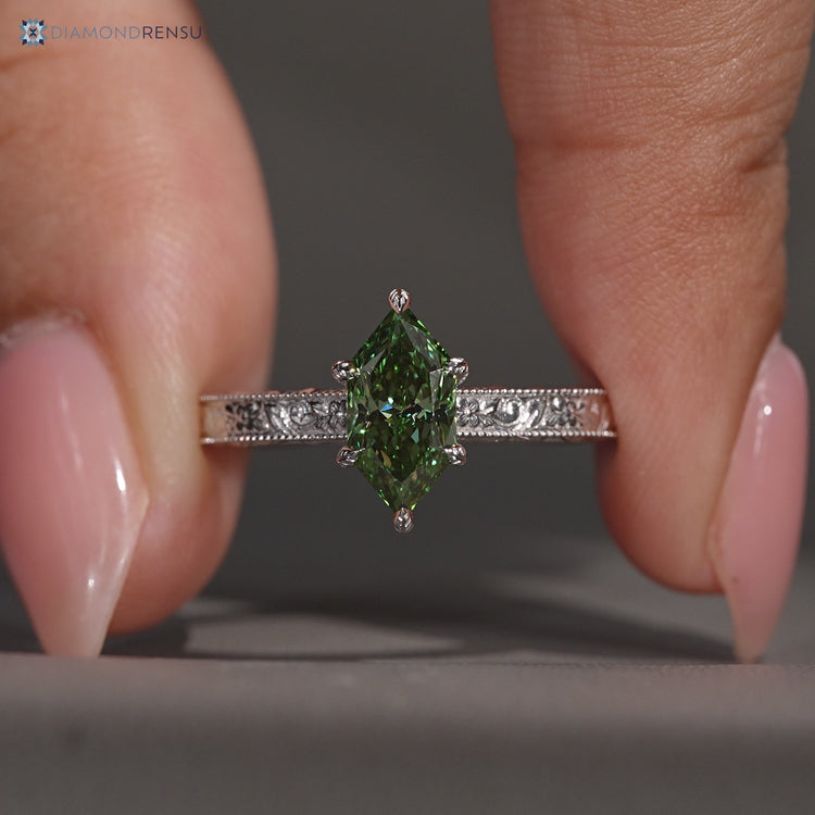 Dutch marquise diamond ring with a green center stone.