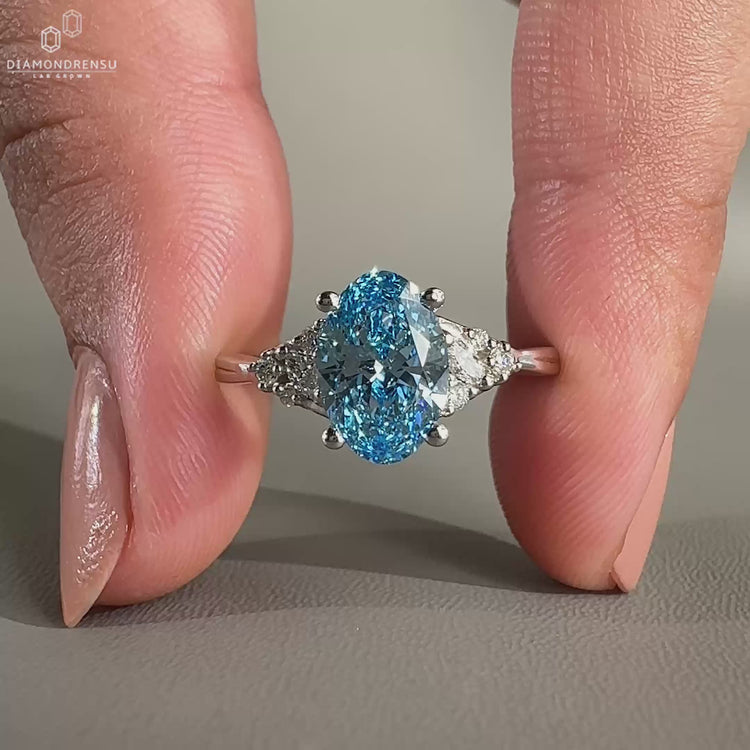 Oval Blue Diamond Ring set in a unique muse setting.