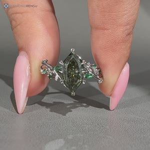 Green center stone defines this Dutch marquise diamond ring with a nature inspired style.