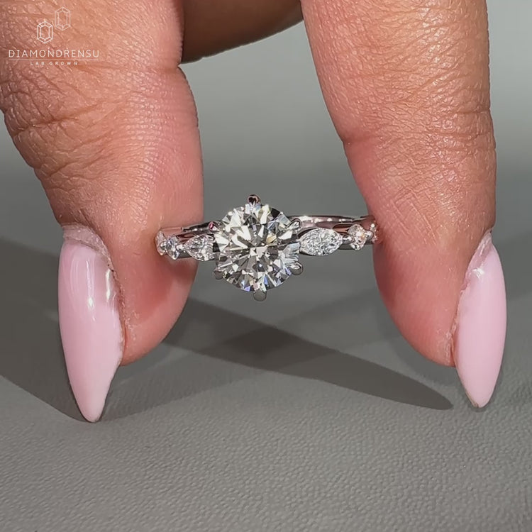 Side stone engagement ring with a sparkling diamond accent.
