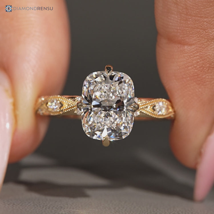Cushion cut diamond ring with round and marquise stones.
