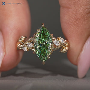 Green marquise center stone in a nature inspired engagement ring.