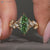 Green marquise center stone in a nature inspired engagement ring.