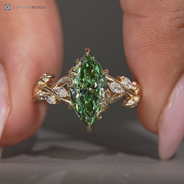 Green marquise center stone in a nature inspired engagement ring.