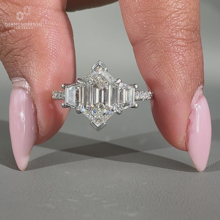 Trapezoid side stones add a unique touch to this ring design.
