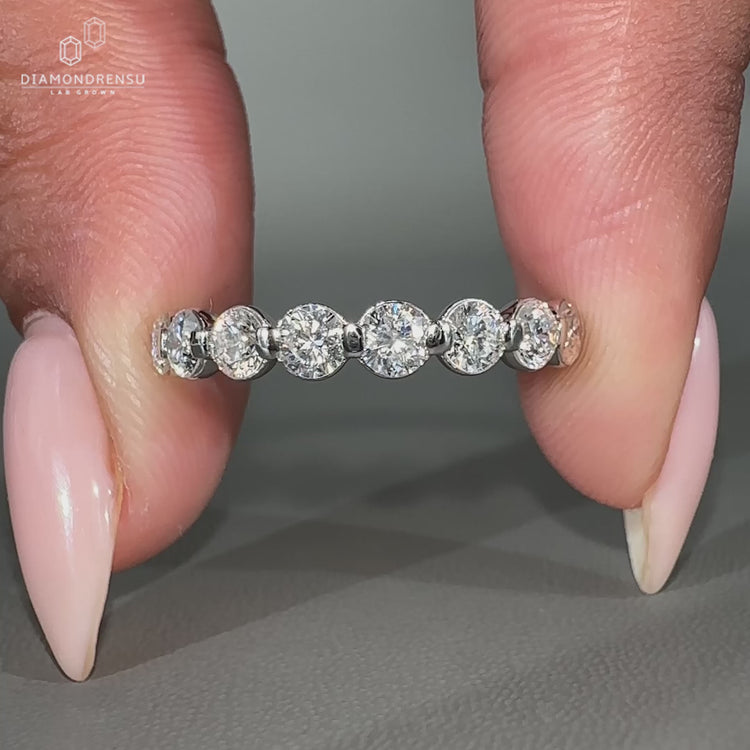 Round diamond half eternity band shared prong wedding band
