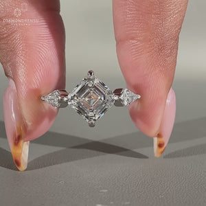Kite side stones enhancing the diamond ring's elegance.
