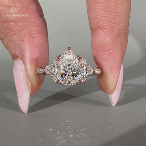 Vintage engagement ring with pear and round side stones.
