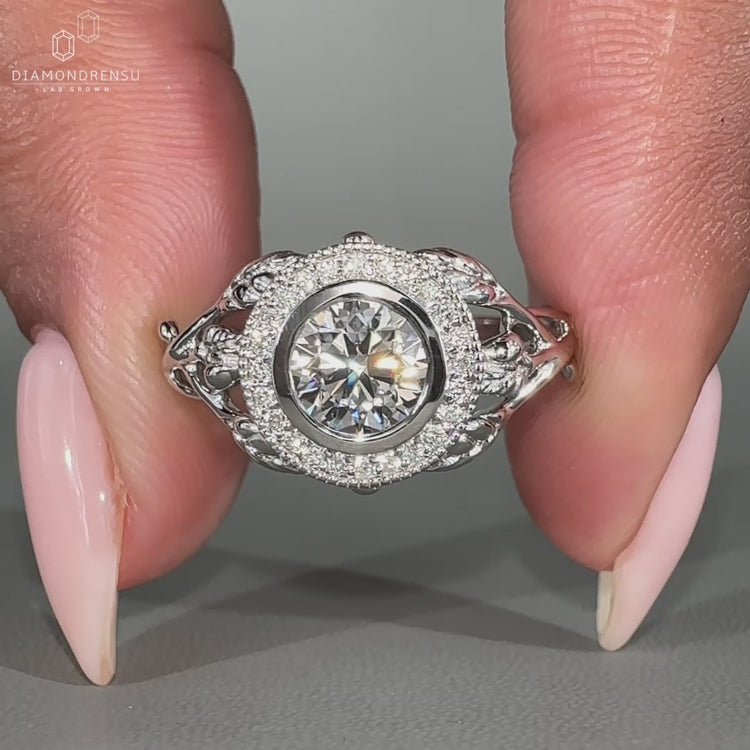 Unique nature inspired ring featuring a round cut diamond in a vintage milgrain setting.
