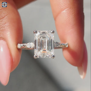 Elegant marquise moissanite ring paired with a beautiful emerald cut center stone.
