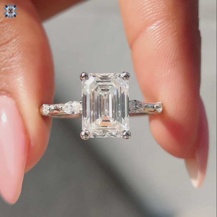 Elegant marquise moissanite ring paired with a beautiful emerald cut center stone.
