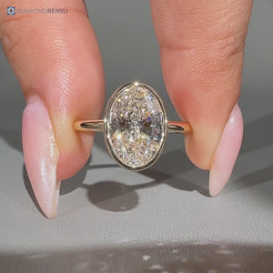 Oval cut bezel engagement ring.