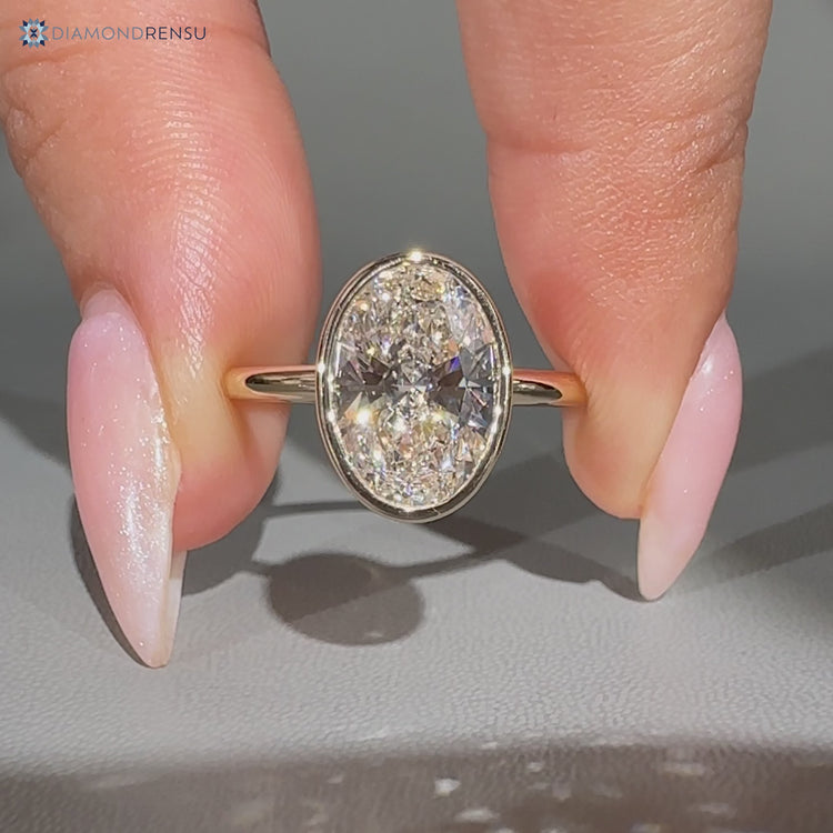 Oval cut bezel engagement ring.