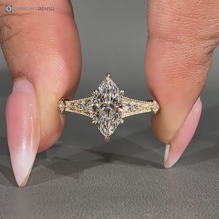 Lab grown marquise diamond ring with round diamond side stones.