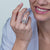 Pave round diamond ring with pear center.