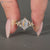 Lab grown hexagon diamond ring with marquise and round side stones.