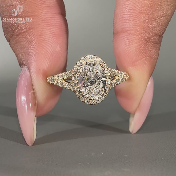 Lab grown oval diamond ring with round pave band and halo setting.