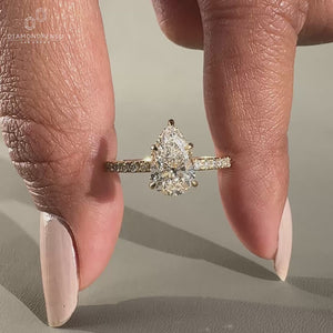 Teardrop diamond in a hidden halo engagement ring showcasing elegance.
