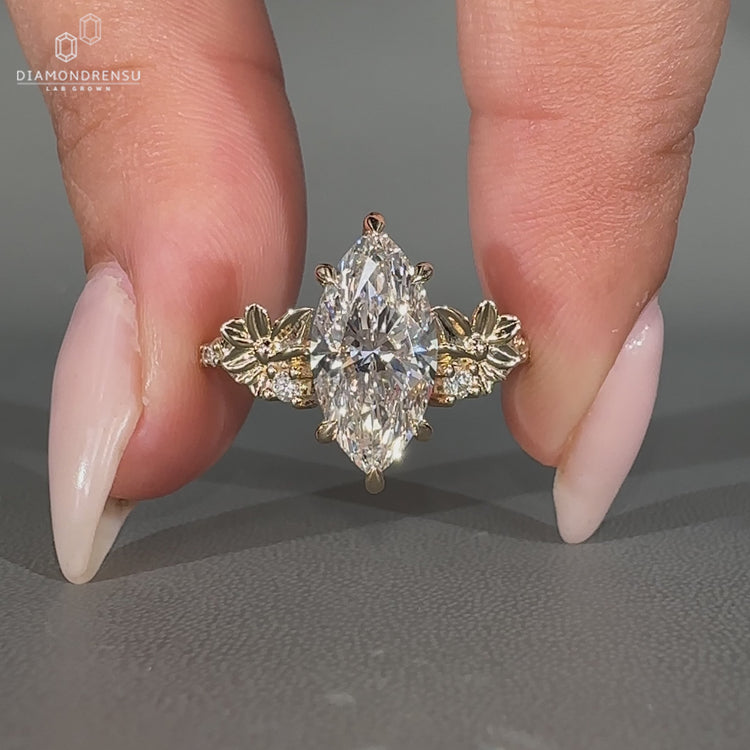 Lab grown marquise cut ring with pave band and prongs.