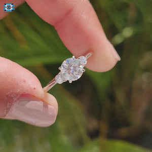 Handmade round cut moissanite engagement ring with four claw prongs.