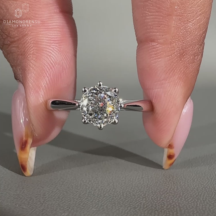 Solitaire ring with eight prong setting holding a lab grown diamond.
