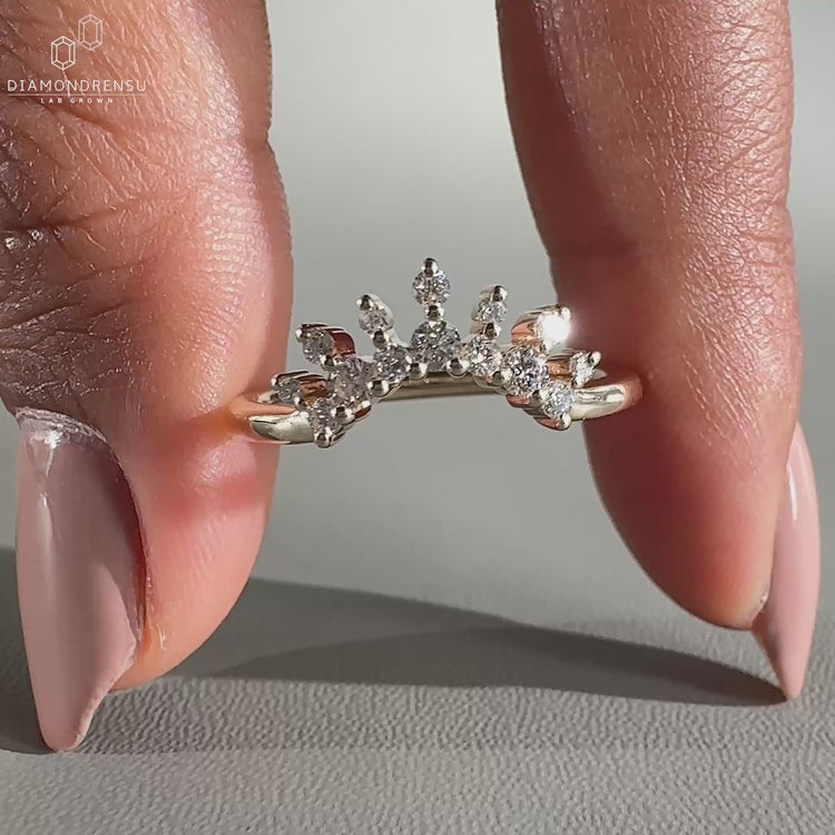 Crown wedding band featuring a sparkling diamond setting.
