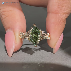 Green dutch marquise paired with round side stones and cluster setting.