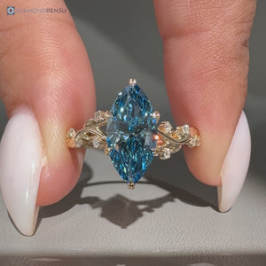 Blue marquise engagement ring in a nature inspired style.