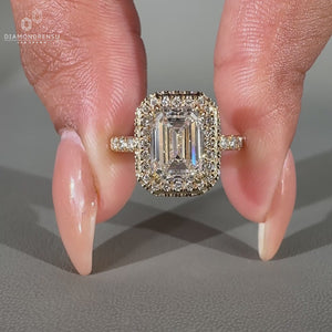 Pave diamond ring in an emerald halo design.
