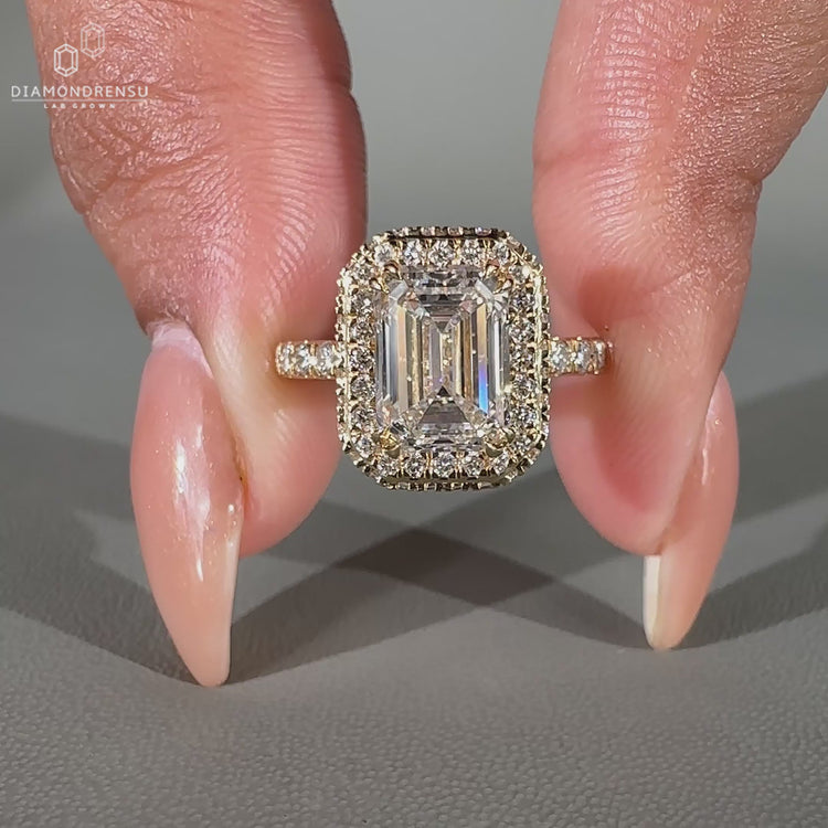 Pave diamond ring in an emerald halo design.
