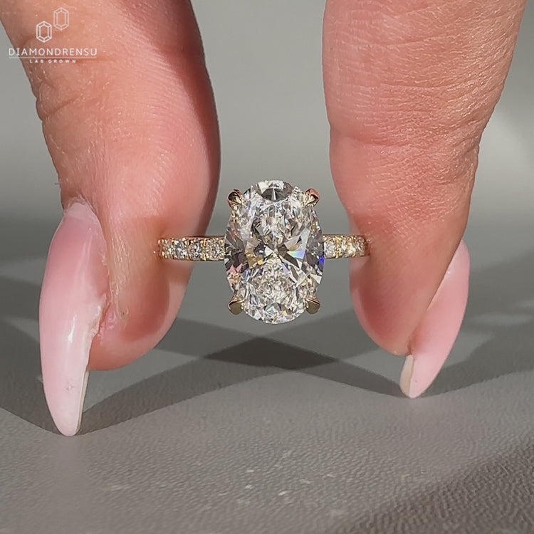 Handmade oval cut diamond ring with round cut hidden accents.