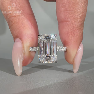 Emerald cut diamond ring with pave band.

