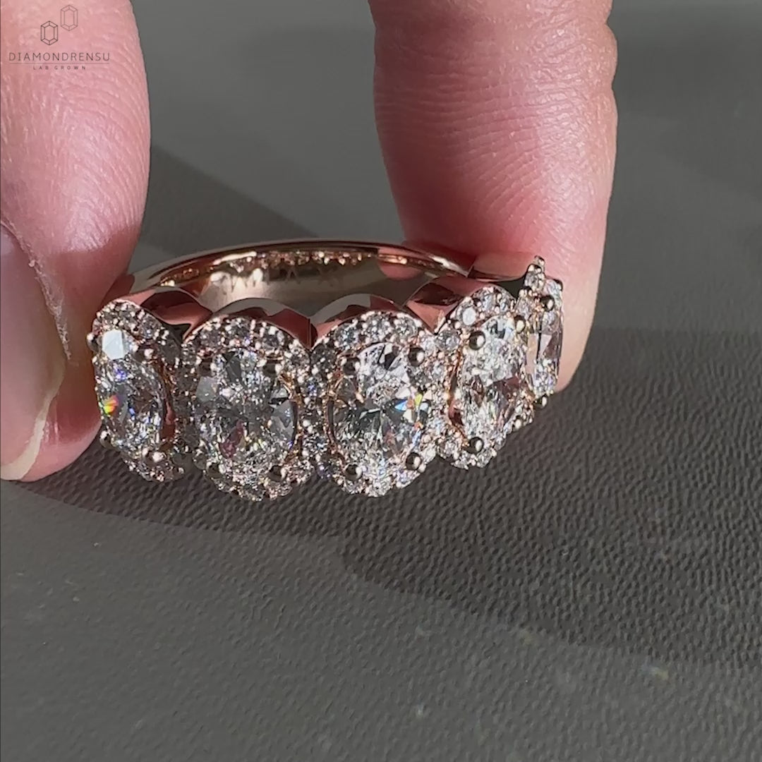 Elegant 5 stone engagement ring with a row of sparkling diamonds.
