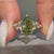 Green Dutch marquise engagement ring with round side stones.
