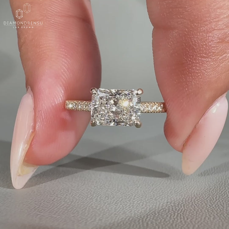 East to west diamond ring with a claw prong ring setting, offering a modern touch.
