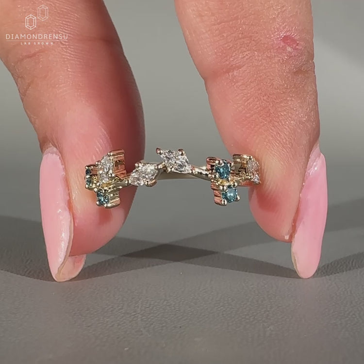 Nature inspired wedding band made with a blue round diamond.
