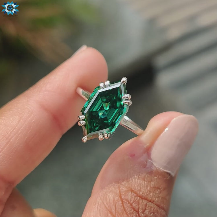 Green engagement ring featuring a Dutch Marquise step cut.
