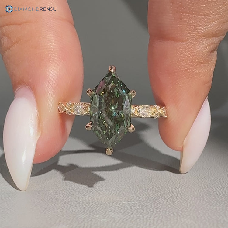 Green Dutch marquise diamond ring with milgrain details.