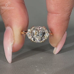 Lab grown old Mine cut diamond ring with round side stones.
