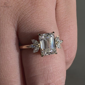 Elegant emerald cut ring featuring six marquise side stones for added brilliance.
