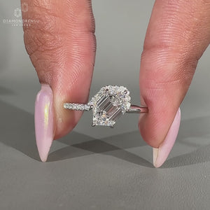 White gold engagement ring with hexagon diamond and unique halo setting.
