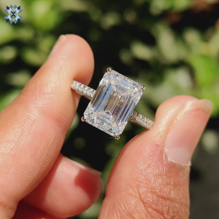 Hidden halo moissanite ring sparkling under soft lighting.
