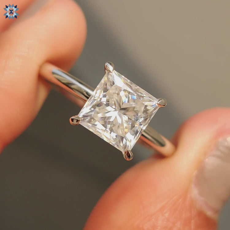 Hidden halo engagement ring featuring a brilliant princess cut.
