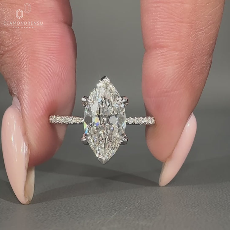 White gold marquise engagement ring with pave setting.
