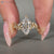 Lab grown marquise diamond ring with marquise and round side stones.