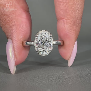 Oval Cut Diamond Ring with a stunning round cut diamond halo setting.
